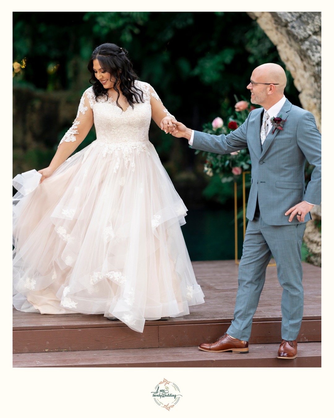 groom holding bride's hand while she walks down steps