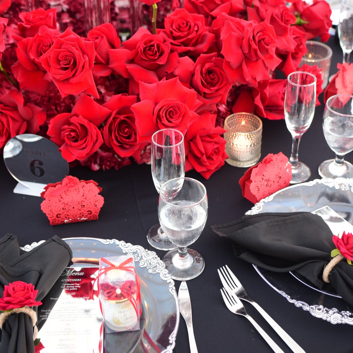 black and red wedding reception decor with red rose centerpiece