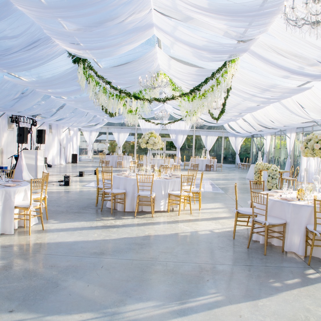 white and gold wedding reception decor under tent